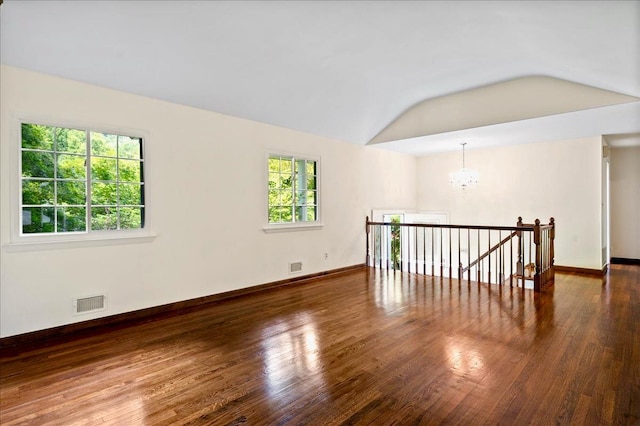 205 Radcliff Dr, Nyack, NY 10960 - empty room with vaulted ceiling, a chandelier, and wood finished floors