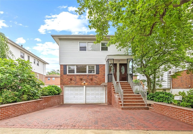 205-06 26th Ave, Bayside, NY 11360 - view of front of property with an attached garage, decorative driveway, and brick siding