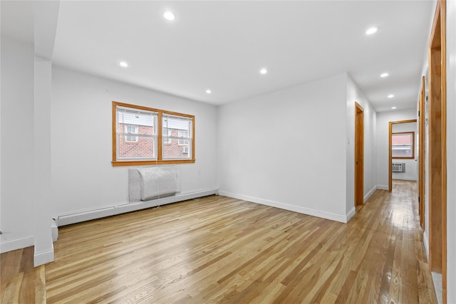 205-06 26th Ave, Bayside, NY 11360 - empty room with healthy amount of natural light, light wood finished floors, baseboard heating, and recessed lighting
