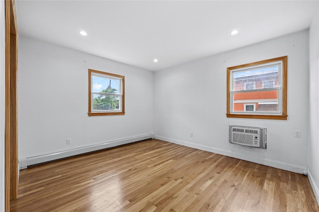 205-06 26th Ave, Bayside, NY 11360 - spare room featuring a baseboard heating unit, a wall mounted air conditioner, light wood-style flooring, and recessed lighting