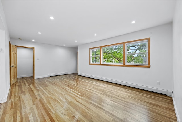 205-06 26th Ave, Bayside, NY 11360 - spare room featuring a baseboard heating unit, light wood-style flooring, and recessed lighting