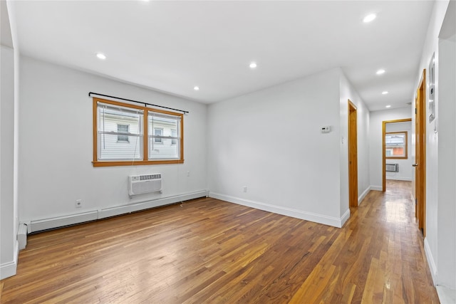 205-06 26th Ave, Bayside, NY 11360 - empty room with baseboard heating, hardwood / wood-style flooring, recessed lighting, and a wall unit AC
