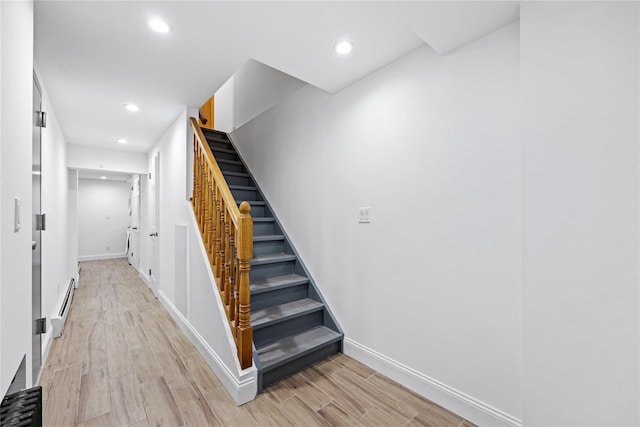 205-06 26th Ave, Bayside, NY 11360 - stairway with a baseboard heating unit, wood finished floors, and recessed lighting