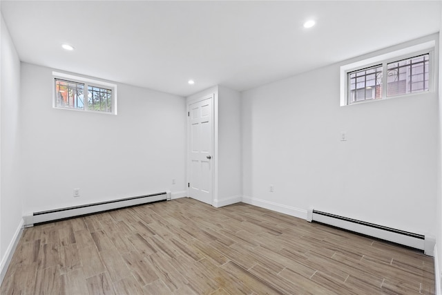 205-06 26th Ave, Bayside, NY 11360 - basement with a baseboard radiator, light wood-type flooring, and recessed lighting