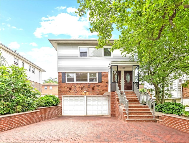 205-06 26th Ave, Bayside, NY 11360 - view of front of property featuring an attached garage, decorative driveway, and brick siding