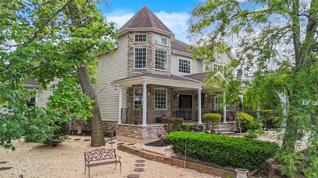 66 Normalee Rd, Staten Island, NY 10305 - view of front of home with stone siding, a porch, and roof with shingles