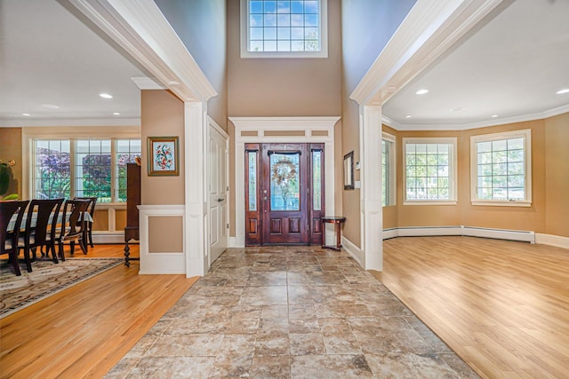 66 Normalee Rd, Staten Island, NY 10305 - foyer entrance with ornamental molding, healthy amount of natural light, baseboard heating, wood finished floors, and a towering ceiling