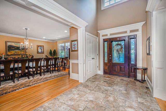66 Normalee Rd, Staten Island, NY 10305 - foyer entrance featuring a chandelier, ornamental molding, and stone finish floors