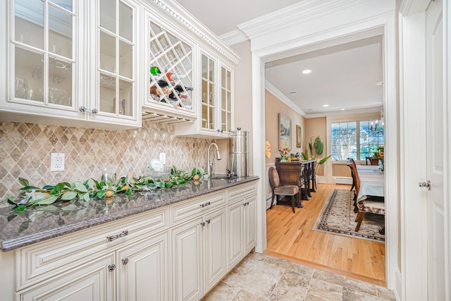 66 Normalee Rd, Staten Island, NY 10305 - indoor wet bar featuring crown molding, tasteful backsplash, light stone finish flooring, recessed lighting, and a baseboard radiator