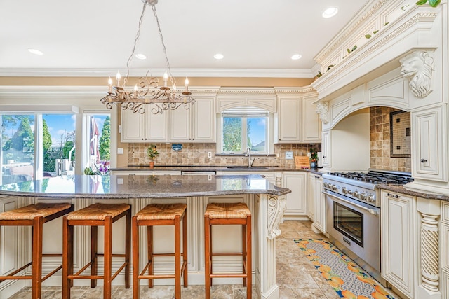 66 Normalee Rd, Staten Island, NY 10305 - kitchen with high end stainless steel range oven, a breakfast bar area, a chandelier, ornamental molding, and tasteful backsplash