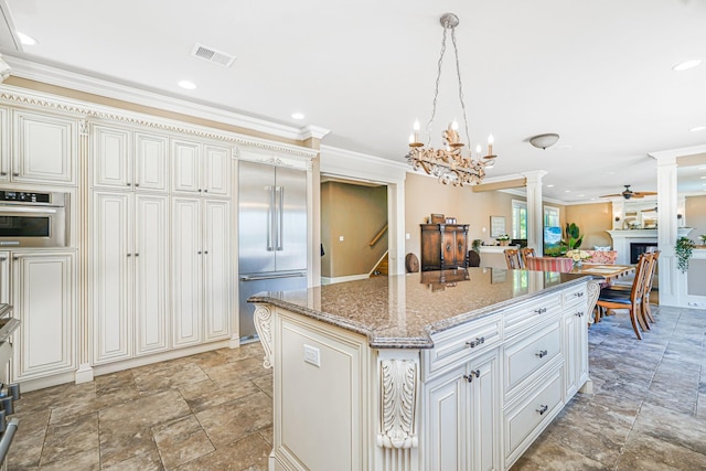 66 Normalee Rd, Staten Island, NY 10305 - kitchen featuring stainless steel built in fridge, a chandelier, crown molding, light stone counters, and ornate columns