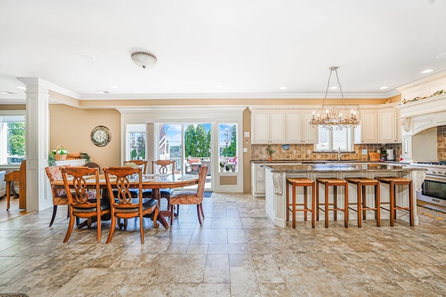 66 Normalee Rd, Staten Island, NY 10305 - dining space with crown molding, plenty of natural light, stone tile floors, a chandelier, and decorative columns