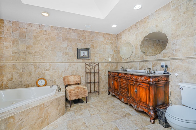 66 Normalee Rd, Staten Island, NY 10305 - bathroom with tile walls, a skylight, recessed lighting, a tub with jets, and double vanity