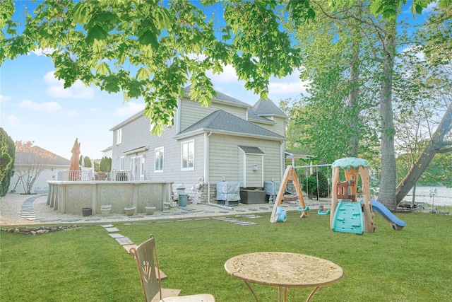 66 Normalee Rd, Staten Island, NY 10305 - back of house with a playground, a yard, a shingled roof, and an outdoor pool