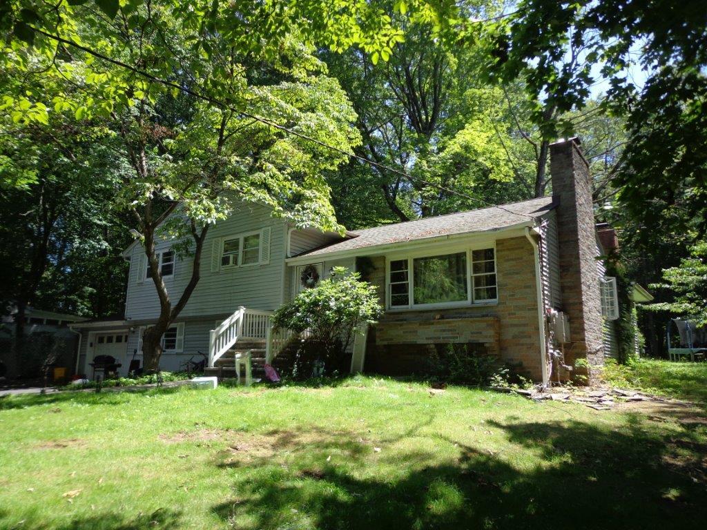 286 Spook Rock Rd, Suffern, NY 10901 - view of front of house with a chimney and a front lawn