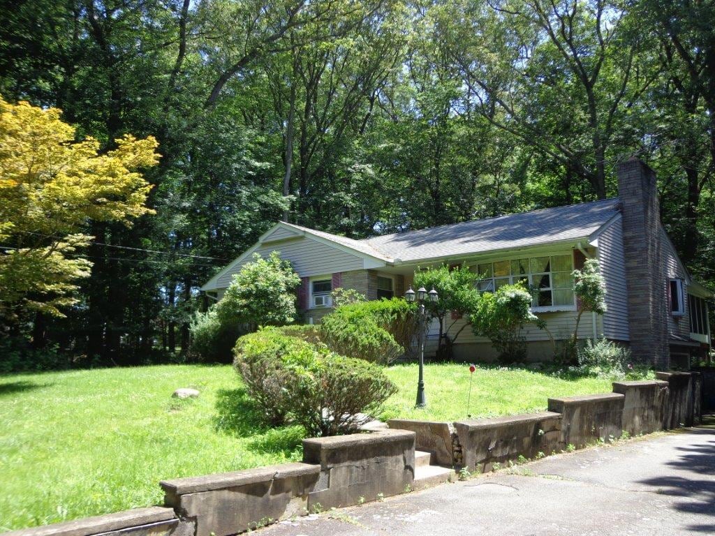 286 Spook Rock Rd, Suffern, NY 10901 - view of front of home with a chimney and a front yard
