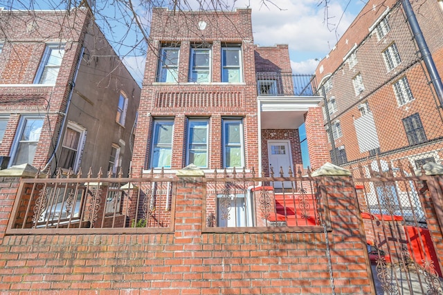 610 Sheffield Ave, Brooklyn, NY 11207 - view of front of home with brick siding and a fenced front yard