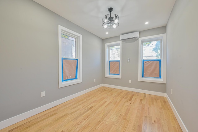 610 Sheffield Ave, Brooklyn, NY 11207 - empty room with a wall mounted air conditioner, light wood-style flooring, and recessed lighting