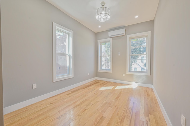 610 Sheffield Ave, Brooklyn, NY 11207 - empty room featuring a wall mounted air conditioner and light wood-style floors