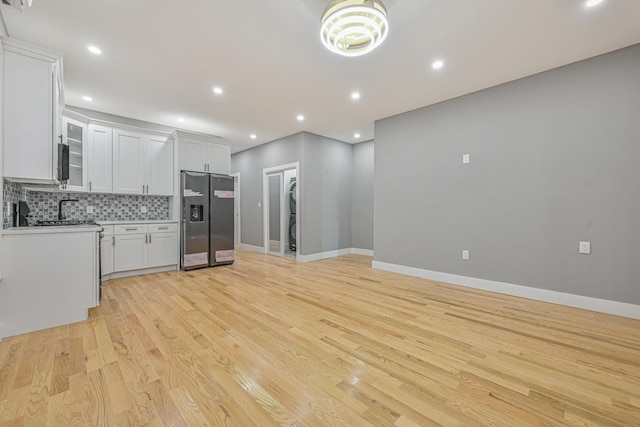 610 Sheffield Ave, Brooklyn, NY 11207 - kitchen with stainless steel fridge with ice dispenser, light wood finished floors, tasteful backsplash, light countertops, and recessed lighting