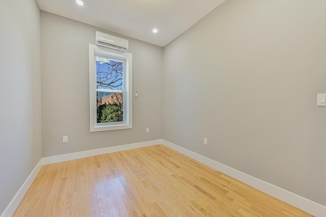 610 Sheffield Ave, Brooklyn, NY 11207 - empty room with an AC wall unit, light wood-style flooring, and recessed lighting
