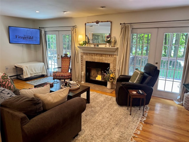 18 Division St, Cornwall, NY 12518 - living area with french doors, wood finished floors, radiator, a fireplace, and recessed lighting