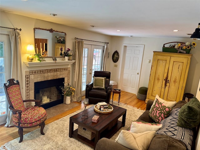 18 Division St, Cornwall, NY 12518 - living area featuring plenty of natural light, wood finished floors, a tile fireplace, french doors, and recessed lighting