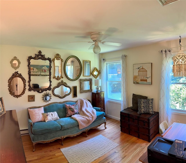 18 Division St, Cornwall, NY 12518 - living area featuring wood finished floors, ceiling fan, and a baseboard heating unit