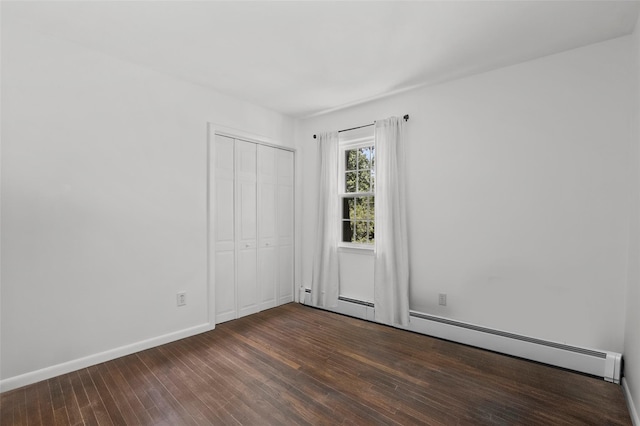 1 Orchard Dr, South Salem, NY 10590 - unfurnished bedroom featuring a baseboard heating unit, dark wood-type flooring, and a closet