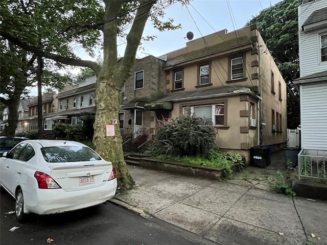 8530 101st St, Richmond Hill, NY 11418 - view of front facade featuring stucco siding