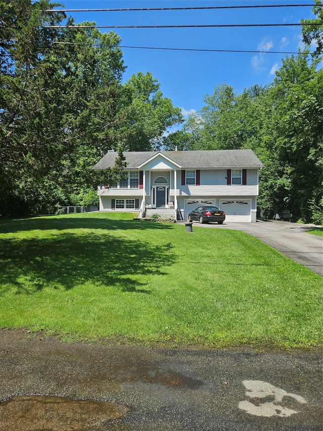 215 Sycamore Dr, New Windsor, NY 12553 - raised ranch featuring driveway, a garage, and a front lawn