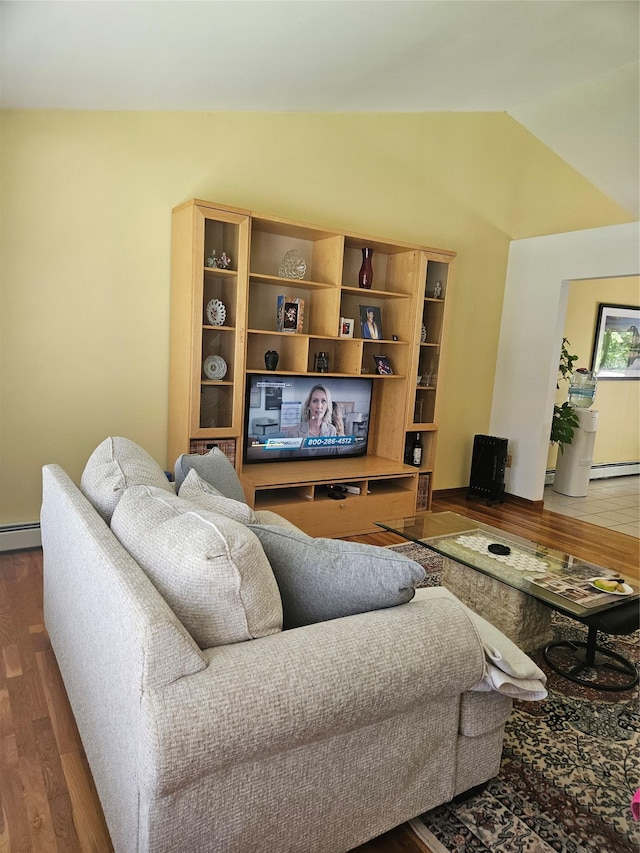 215 Sycamore Dr, New Windsor, NY 12553 - living room with vaulted ceiling, wood finished floors, and a baseboard radiator
