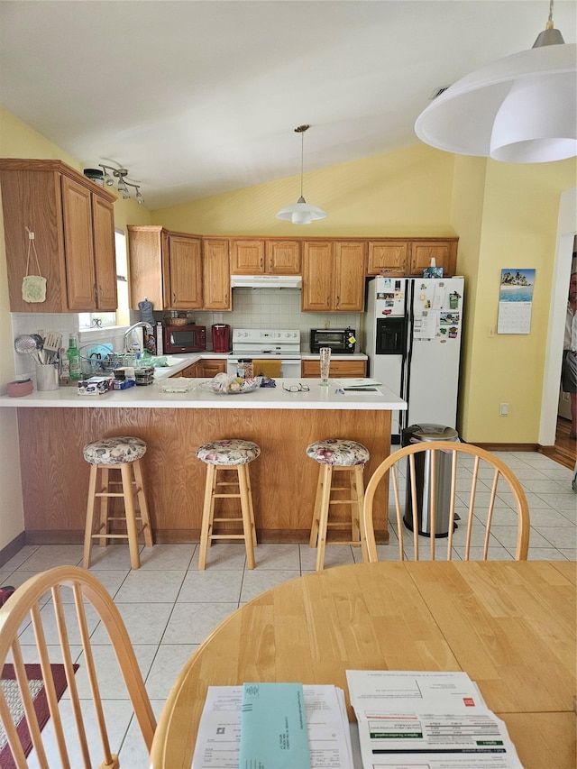 215 Sycamore Dr, New Windsor, NY 12553 - kitchen featuring white appliances, lofted ceiling, light tile patterned flooring, tasteful backsplash, and under cabinet range hood