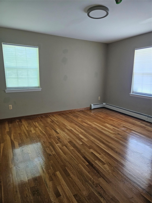 215 Sycamore Dr, New Windsor, NY 12553 - empty room featuring dark wood finished floors and baseboard heating