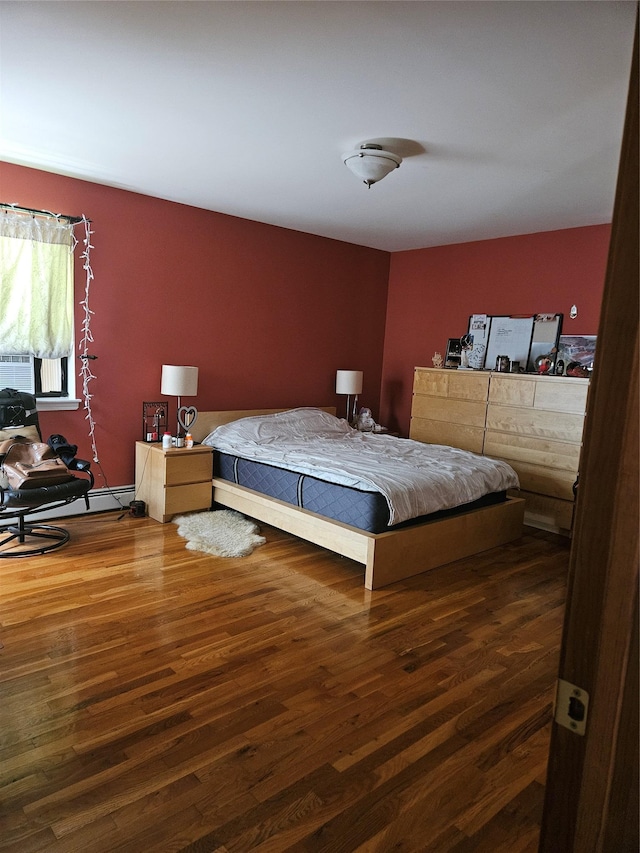 215 Sycamore Dr, New Windsor, NY 12553 - bedroom with wood finished floors and a baseboard heating unit