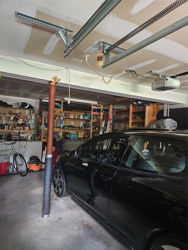 215 Sycamore Dr, New Windsor, NY 12553 - garage with a garage door opener and a workshop area