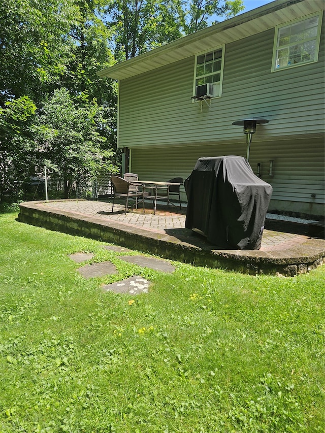 215 Sycamore Dr, New Windsor, NY 12553 - back of property featuring a lawn, a patio, and cooling unit