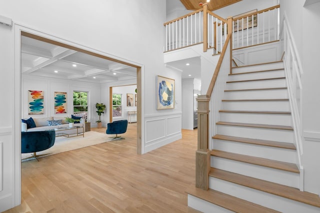 32 Middleville Rd Unit 2, Northport, NY 11768 - stairway featuring a decorative wall, crown molding, wood finished floors, coffered ceiling, and beamed ceiling