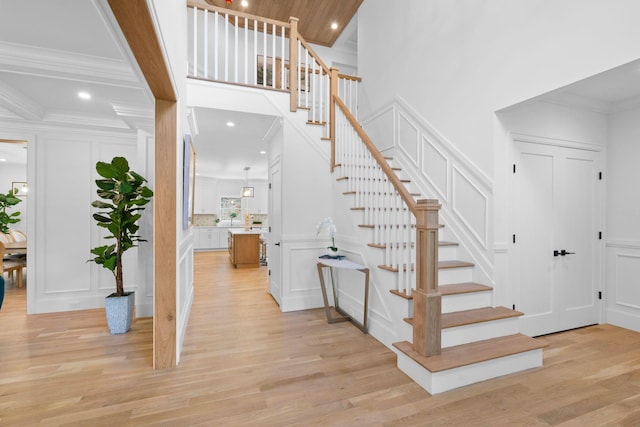 32 Middleville Rd Unit 2, Northport, NY 11768 - staircase featuring a decorative wall, wood finished floors, ornamental molding, and recessed lighting