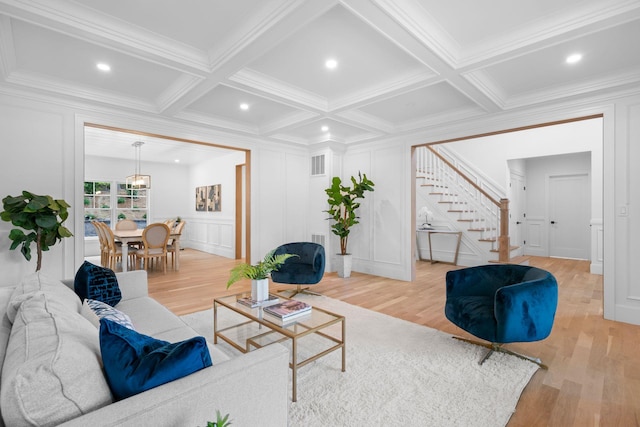 32 Middleville Rd Unit 2, Northport, NY 11768 - living area with a decorative wall, stairs, light wood-type flooring, ornamental molding, and beamed ceiling