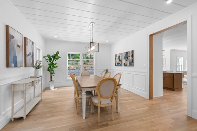 32 Middleville Rd Unit 2, Northport, NY 11768 - dining room featuring a decorative wall, light wood-style flooring, a chandelier, and a wainscoted wall