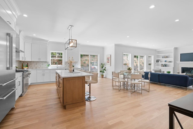 32 Middleville Rd Unit 2, Northport, NY 11768 - kitchen featuring high end appliances, recessed lighting, a center island, crown molding, and tasteful backsplash