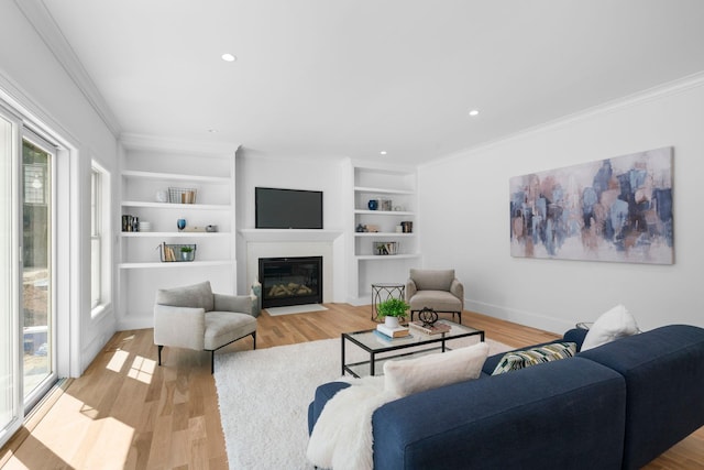 32 Middleville Rd Unit 2, Northport, NY 11768 - living room featuring ornamental molding, light wood-type flooring, a fireplace with flush hearth, built in features, and recessed lighting