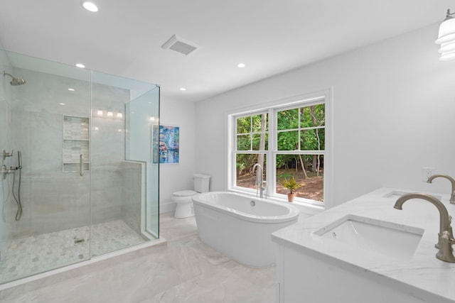 32 Middleville Rd Unit 2, Northport, NY 11768 - full bathroom with marble tiled floors, a stall shower, a freestanding tub, double vanity, and recessed lighting