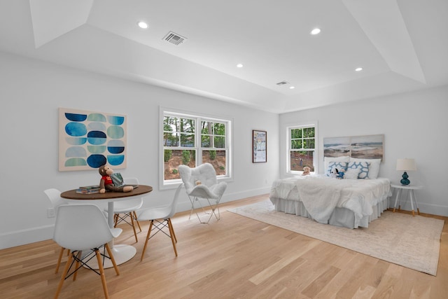 32 Middleville Rd Unit 2, Northport, NY 11768 - bedroom featuring a raised ceiling, light wood-style flooring, multiple windows, and recessed lighting