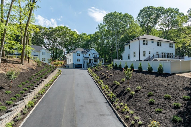 32 Middleville Rd Unit 2, Northport, NY 11768 - view of front of house with stairs, view of scattered trees, and driveway