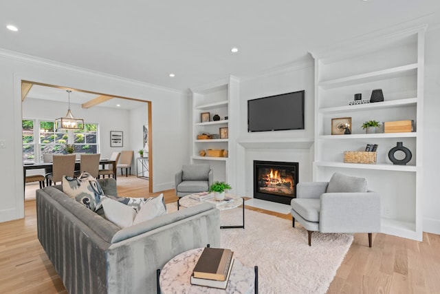 30 Middleville Rd, Northport, NY 11768 - living room with a fireplace with flush hearth, light wood-type flooring, ornamental molding, built in shelves, and recessed lighting