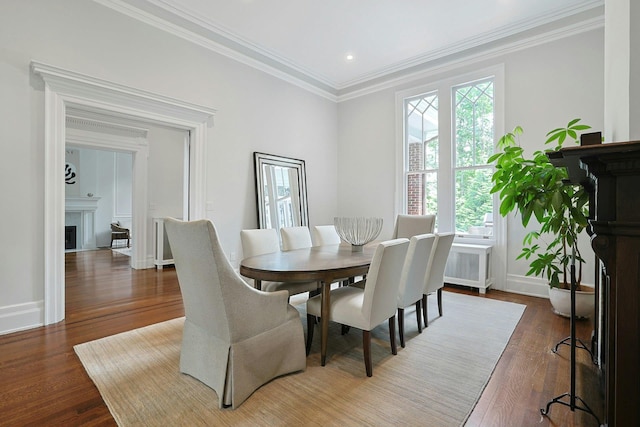 15 Calton Ln, New Rochelle, NY 10804 - dining room featuring a fireplace, wood finished floors, and crown molding