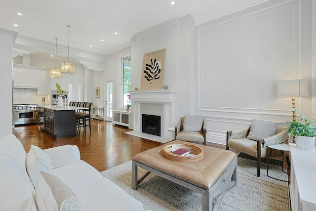 15 Calton Ln, New Rochelle, NY 10804 - living area with crown molding, a fireplace, recessed lighting, and a chandelier