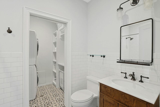 15 Calton Ln, New Rochelle, NY 10804 - full bathroom featuring stacked washer and clothes dryer, tile walls, vanity, wainscoting, and a shower
